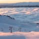 A panoramic photo of lifts ascending the mountain at Cardrona.