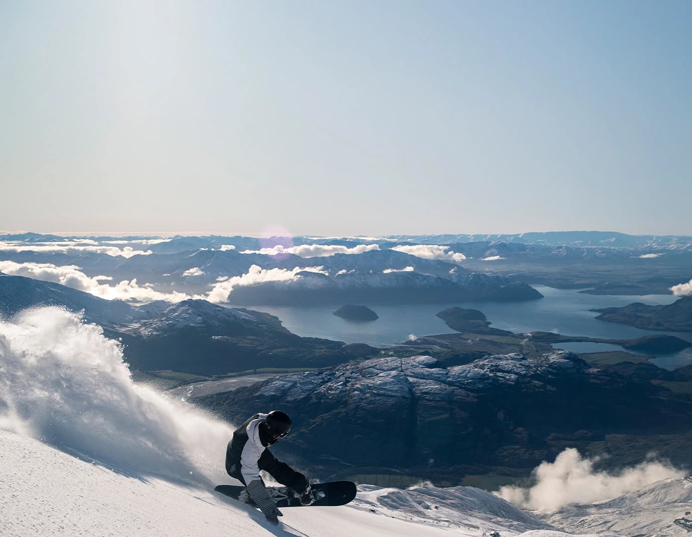 A man snowboards down a steep run at Treble Cone.