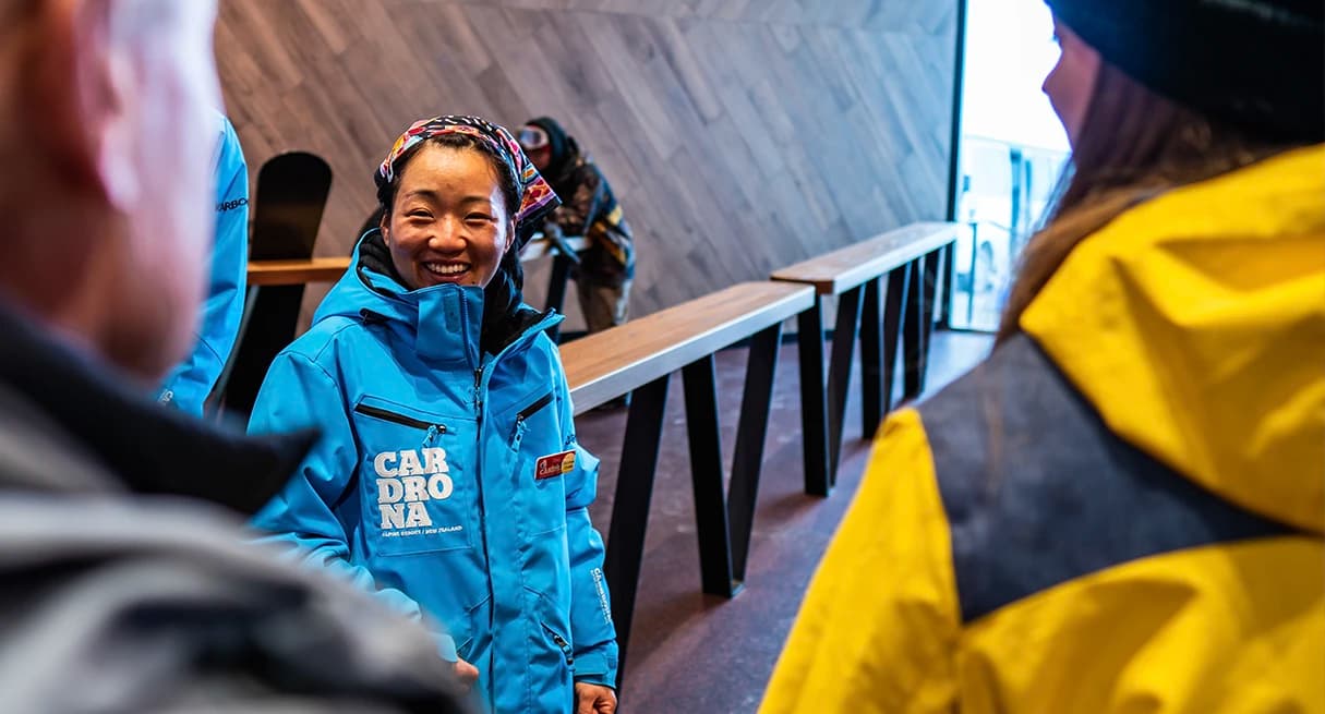 A Cardrona host welcomes guests up the mountain.