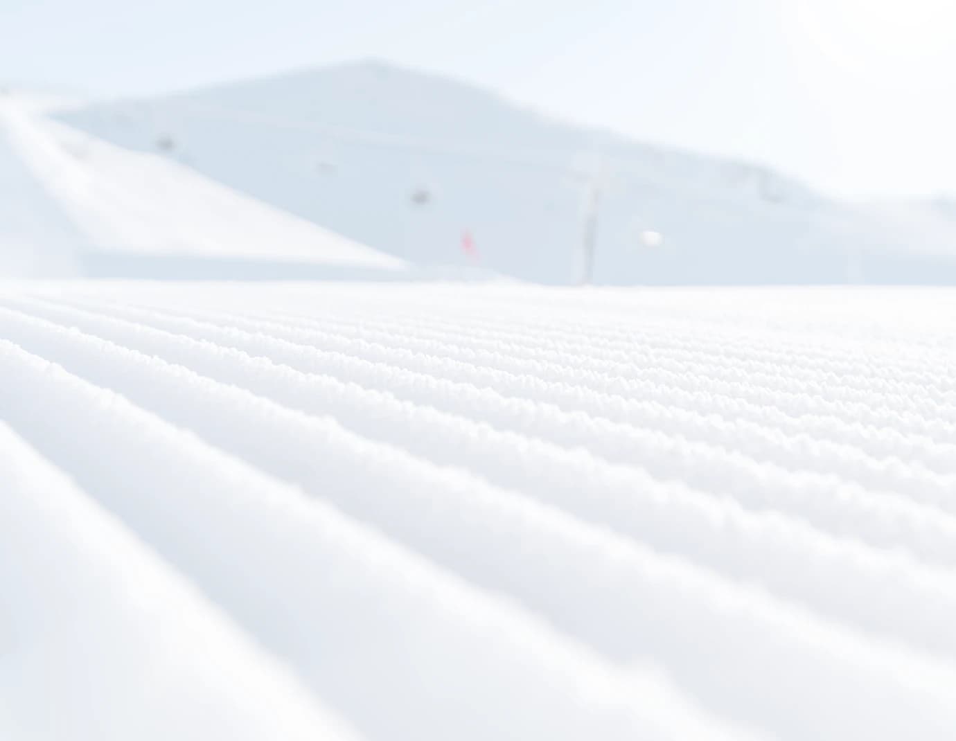 A freshly groomed snow-covered slope.