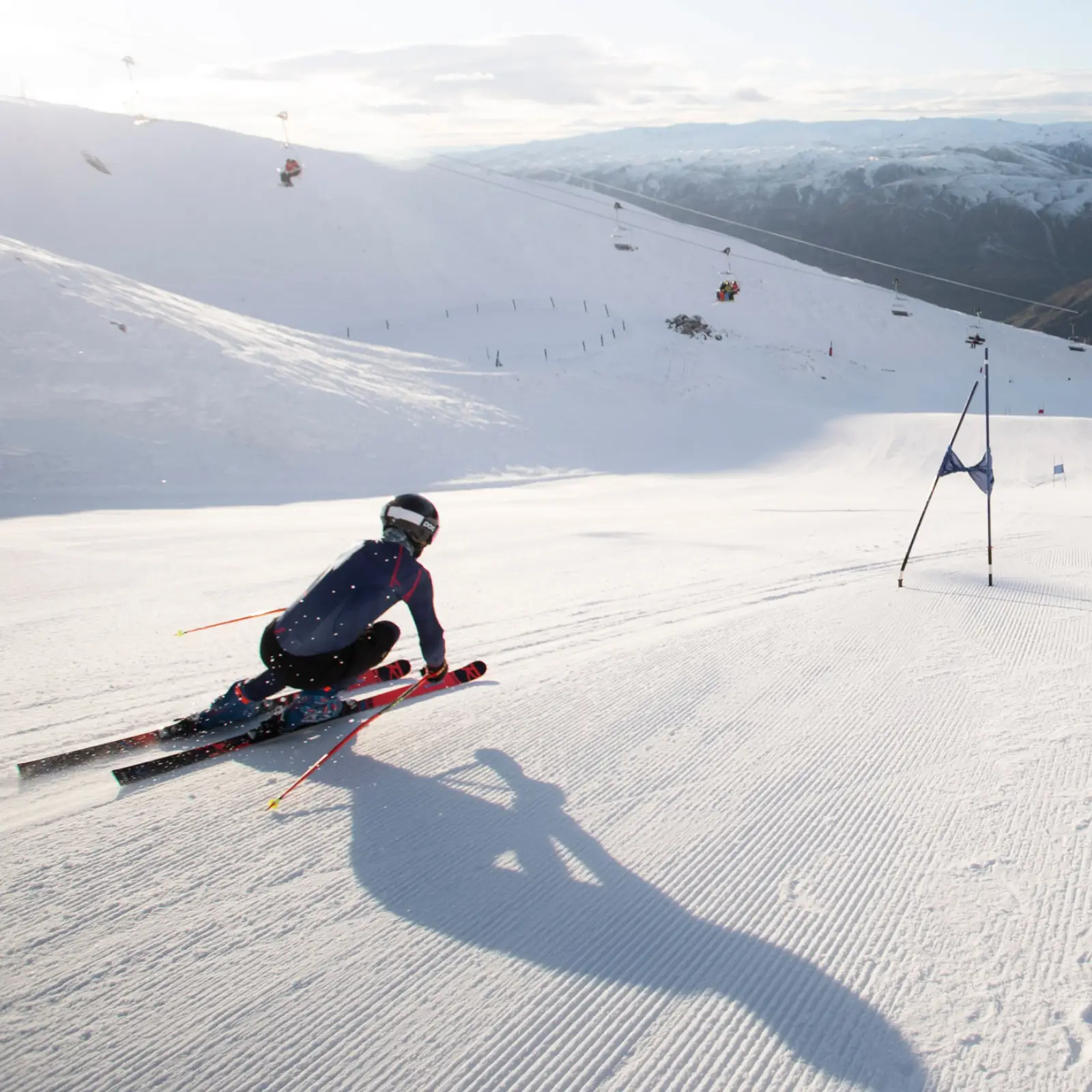 Close-up of skier carving aggressively on a race course.