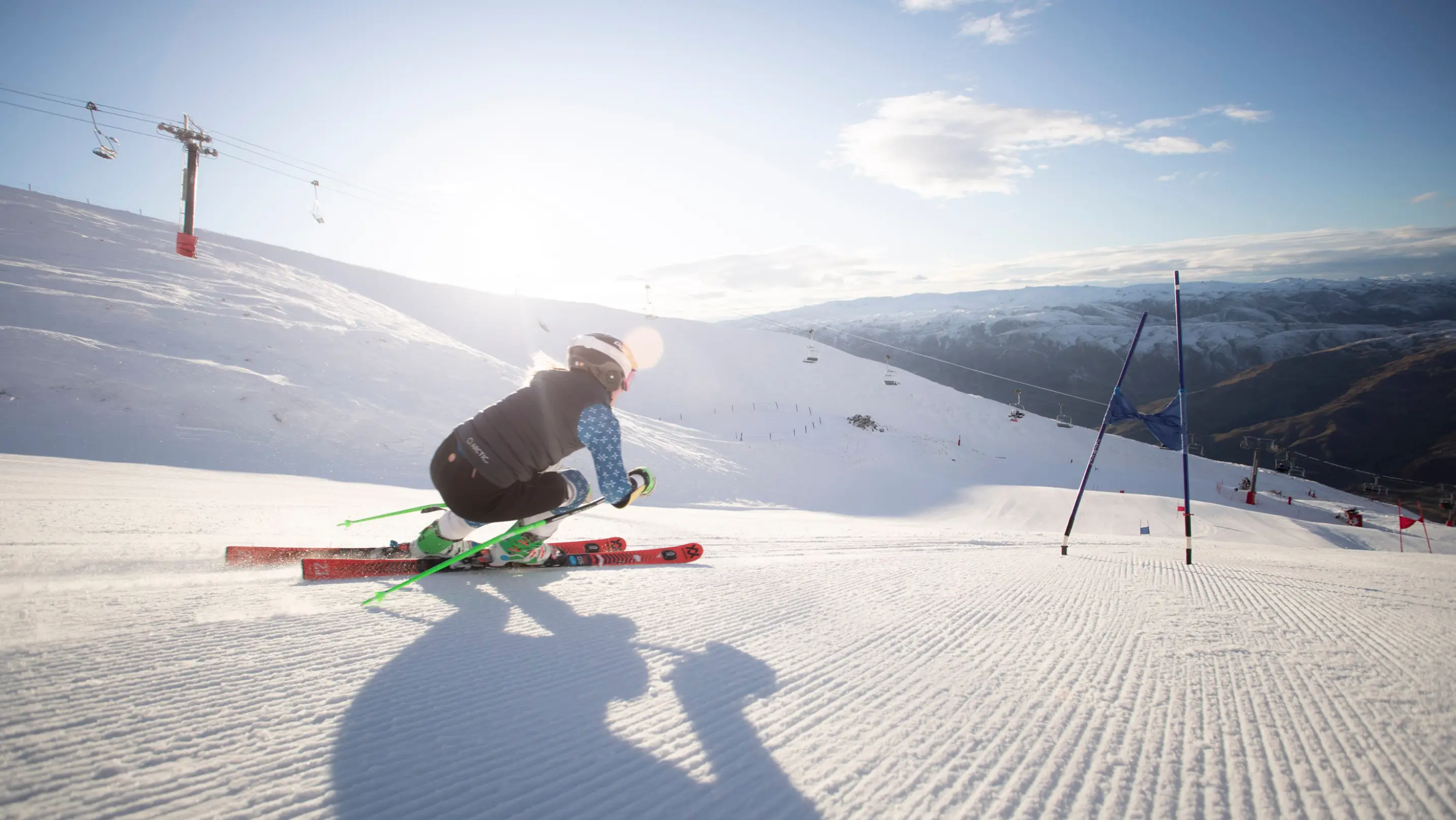 Ski racer carves down groomed run at Cardrona.