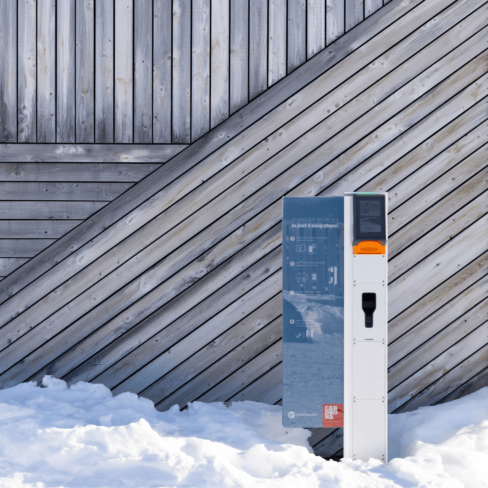 A pick up kiosk sits outside on a snowy day with a wooden background.