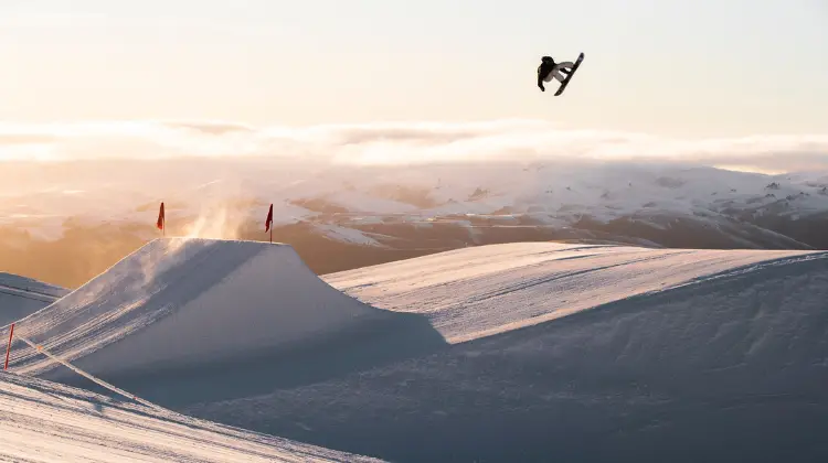 New Zealand snowboarder, Zoi Sadowski-Synnott performs a jump in Cardrona Parks' Antlers Alley.