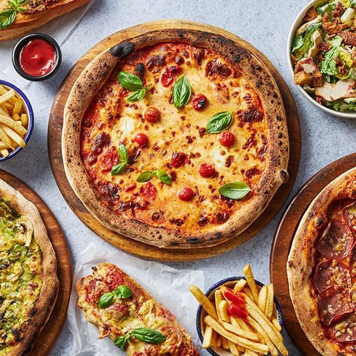 A selection of delicious pizzas and fries.