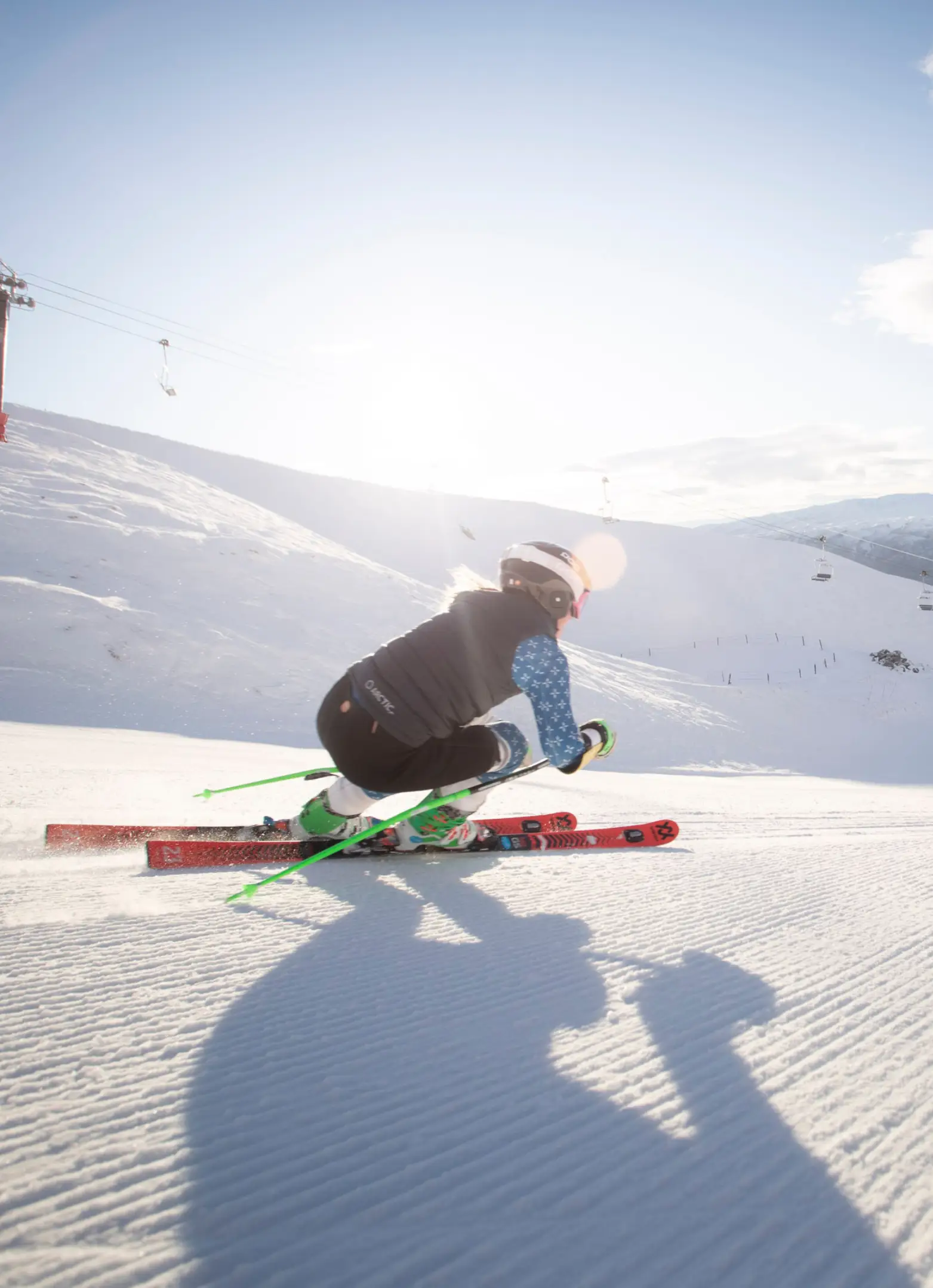 Ski racer carves down groomed run at Cardrona.