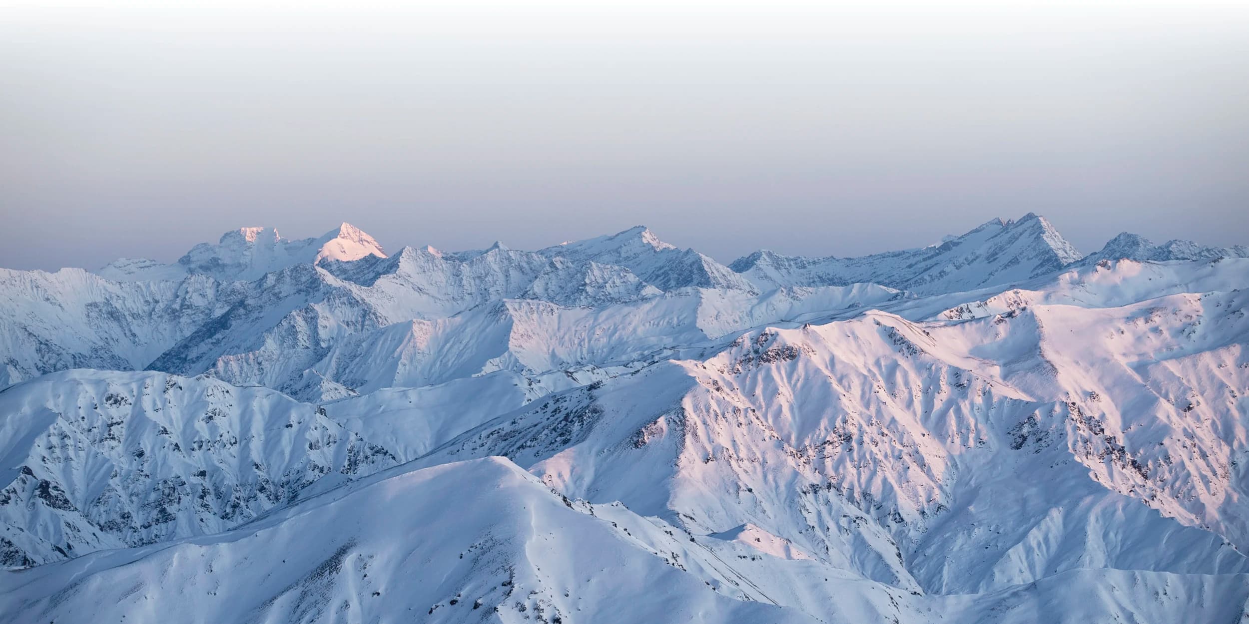 Snow-capped mountains for as far as the eye can see at the top of the Cardrona ski field.